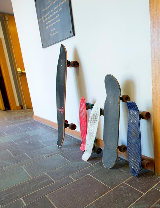 Skateboards leaning up against a wall